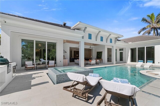 rear view of house with a pool with hot tub, ceiling fan, an outdoor hangout area, exterior kitchen, and a patio