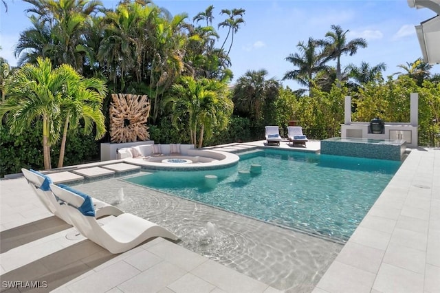 outdoor pool with a patio and an in ground hot tub