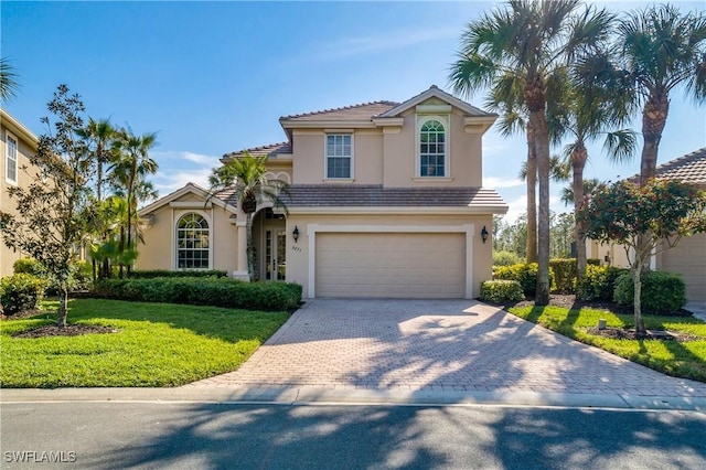 mediterranean / spanish-style house with a garage and a front yard