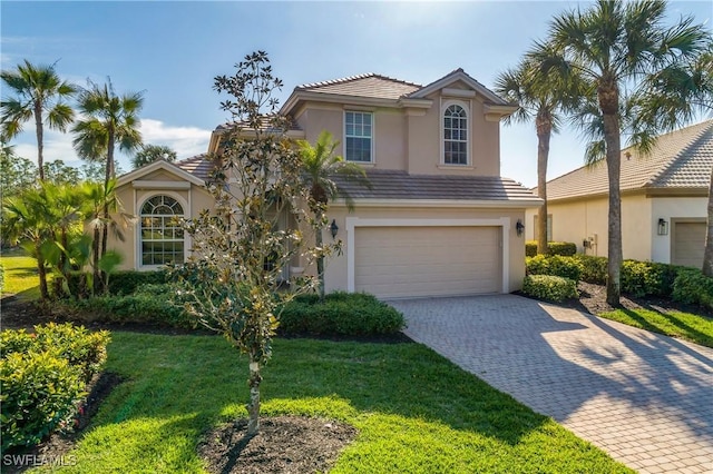 view of front of house featuring a garage and a front lawn