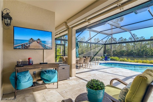 view of swimming pool with a patio, a lanai, and exterior bar