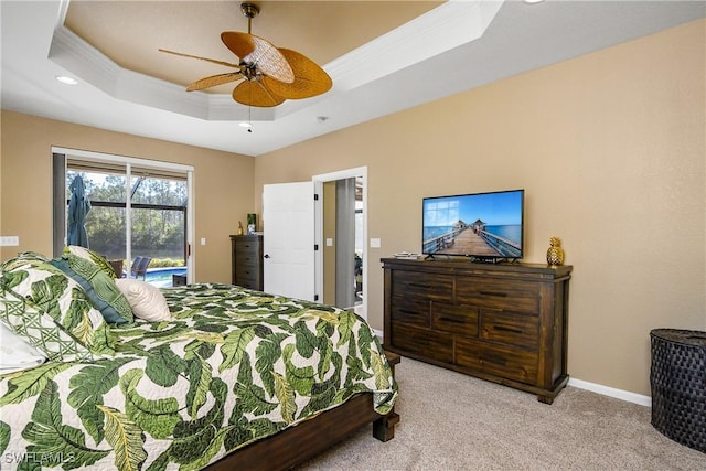 bedroom featuring crown molding, light carpet, access to outside, a tray ceiling, and ceiling fan