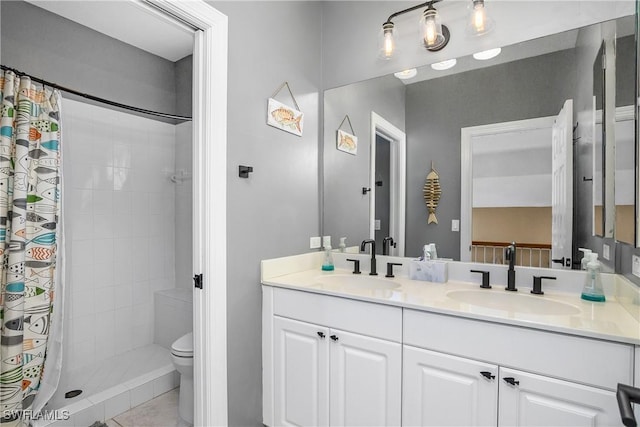 bathroom featuring vanity, curtained shower, and toilet