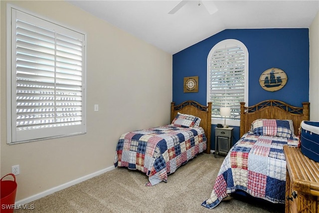 bedroom featuring multiple windows, lofted ceiling, carpet, and ceiling fan