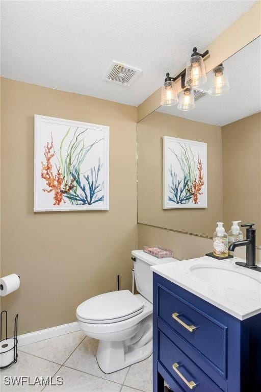 bathroom featuring vanity, tile patterned floors, and toilet