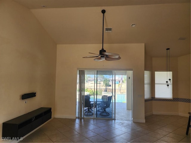 interior space featuring visible vents, baseboards, ceiling fan, and light tile patterned flooring