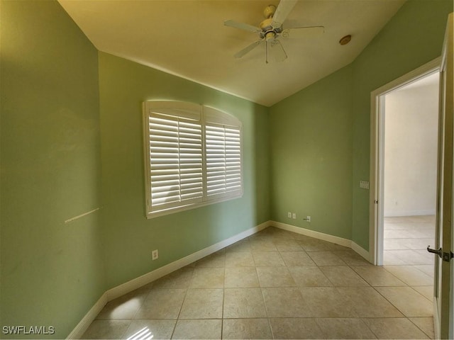 unfurnished room with tile patterned flooring, baseboards, a ceiling fan, and lofted ceiling