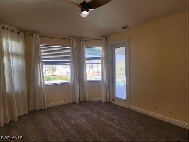 empty room with visible vents, baseboards, carpet, and a ceiling fan