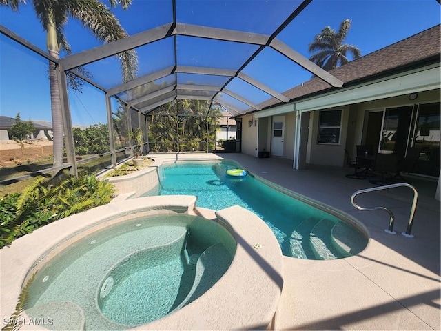 view of pool with glass enclosure, a pool with connected hot tub, and a patio area