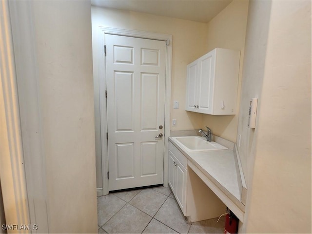 washroom featuring a sink and light tile patterned floors