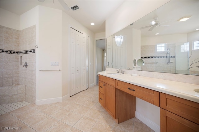10347 Wood Ibis Ave, Bonita Springs, FL 34135 - full bathroom featuring visible vents, ceiling fan, double vanity, tiled shower, and a sink