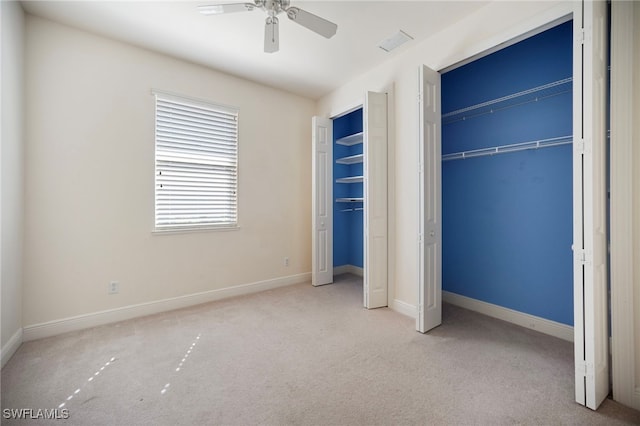 10347 Wood Ibis Ave, Bonita Springs, FL 34135 - unfurnished bedroom with a ceiling fan, baseboards, carpet floors, and multiple closets