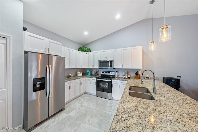 kitchen featuring appliances with stainless steel finishes, white cabinetry, sink, hanging light fixtures, and light stone countertops