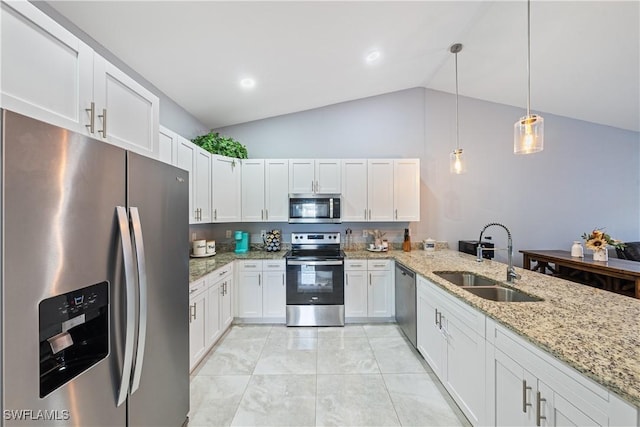 kitchen with lofted ceiling, sink, white cabinetry, stainless steel appliances, and decorative light fixtures