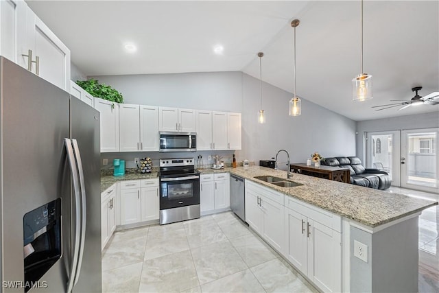 kitchen featuring sink, white cabinetry, hanging light fixtures, appliances with stainless steel finishes, and kitchen peninsula