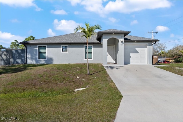 view of front of property with a garage and a front yard