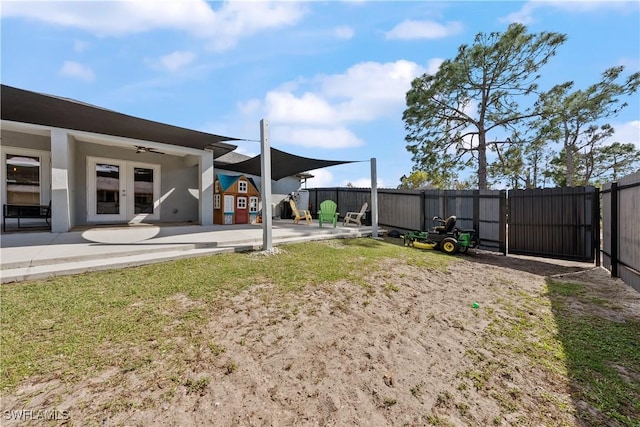 view of yard with a patio area and french doors