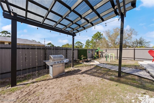 view of patio with a playground, grilling area, and a pergola