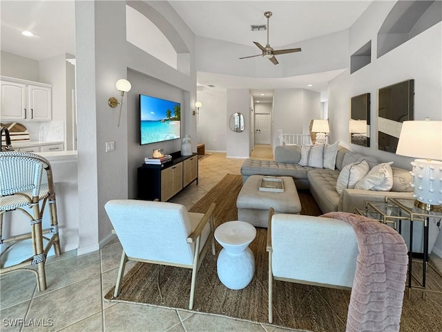 tiled living room with ceiling fan