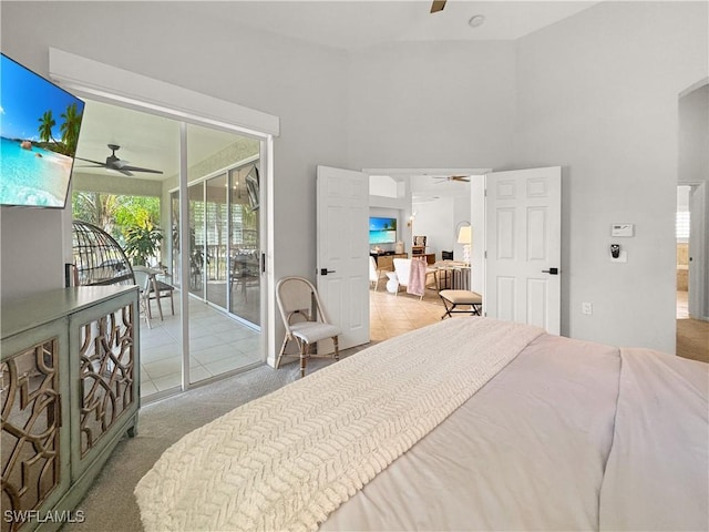 carpeted bedroom with a high ceiling, access to exterior, and ceiling fan