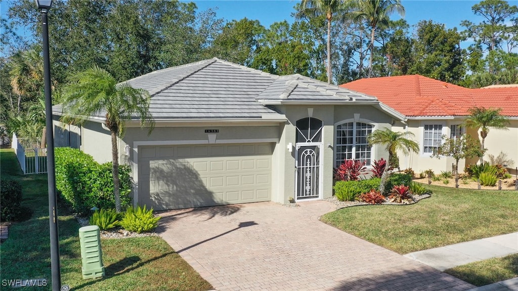 view of front of home with a garage and a front yard