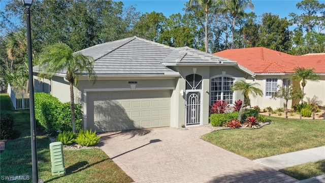 view of front of home with a garage and a front yard