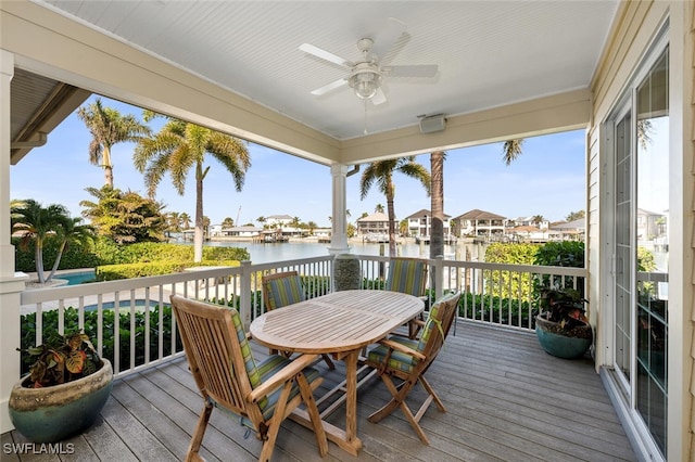 wooden terrace featuring a water view and ceiling fan