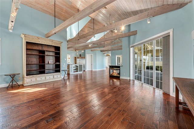 unfurnished living room with wood-type flooring, wooden ceiling, rail lighting, and beamed ceiling