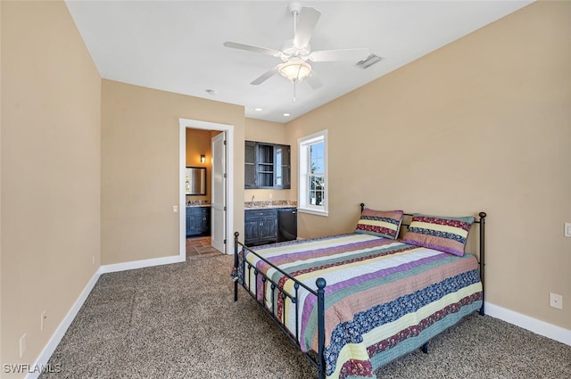 carpeted bedroom with ensuite bathroom and ceiling fan