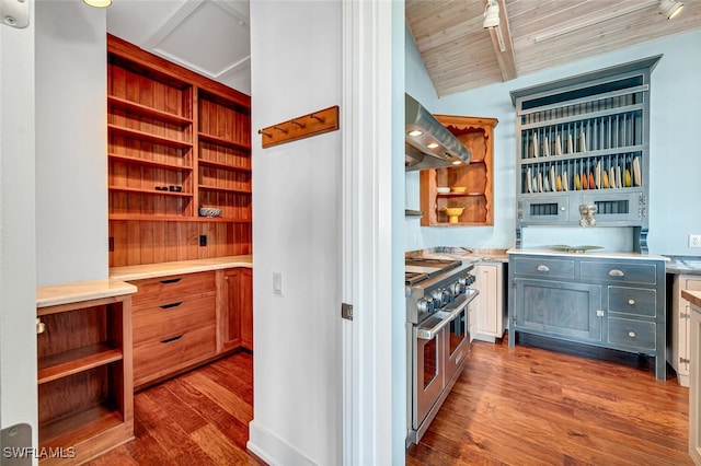 kitchen featuring extractor fan, hardwood / wood-style floors, lofted ceiling with beams, range with two ovens, and wooden ceiling