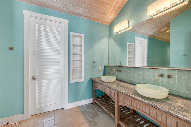 bathroom featuring wood ceiling, vanity, vaulted ceiling, and tasteful backsplash