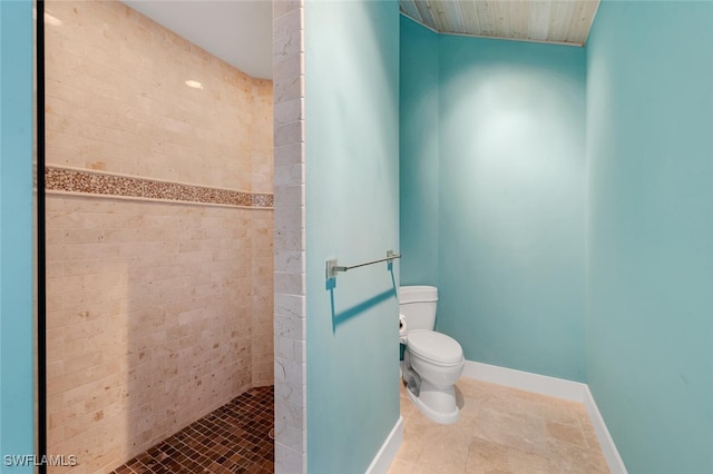 bathroom featuring toilet and tiled shower