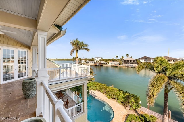 exterior space with french doors, a water view, and a patio