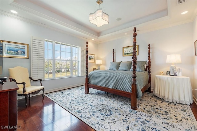 bedroom featuring a tray ceiling, ornamental molding, and dark hardwood / wood-style floors