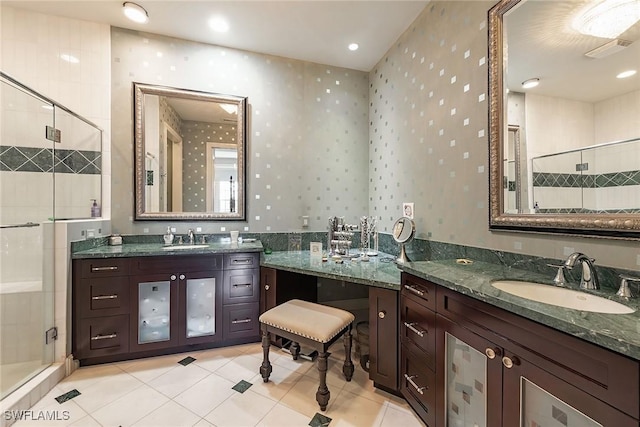 bathroom with tile patterned flooring, vanity, and a shower with shower door