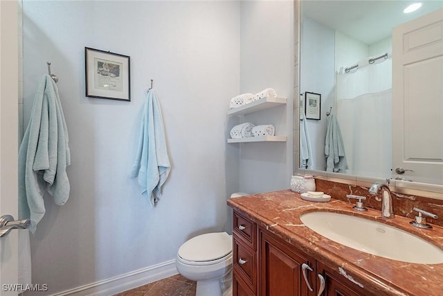 bathroom featuring tile patterned flooring, vanity, walk in shower, and toilet