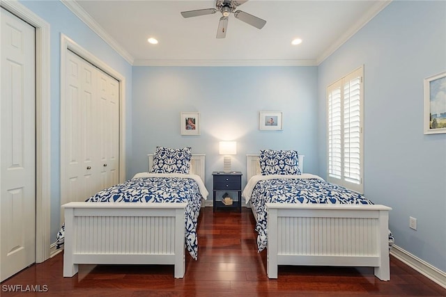 bedroom with multiple closets, ornamental molding, dark hardwood / wood-style floors, and ceiling fan