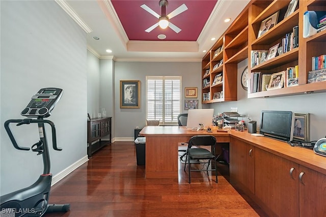 office space featuring crown molding, ceiling fan, dark hardwood / wood-style flooring, and a raised ceiling