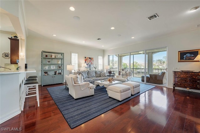 living room featuring dark wood-type flooring and ornamental molding