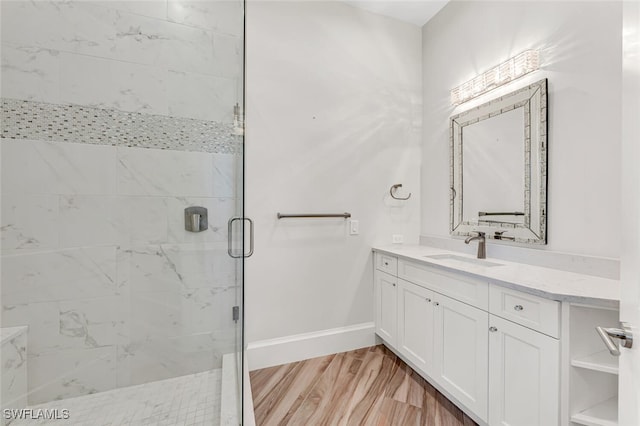 bathroom with wood-type flooring, an enclosed shower, and vanity