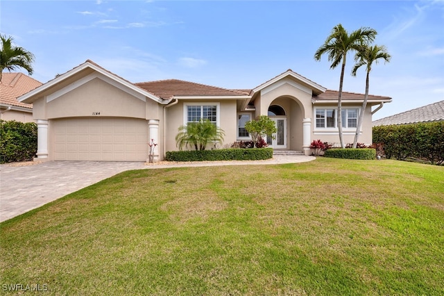 single story home with a garage and a front yard