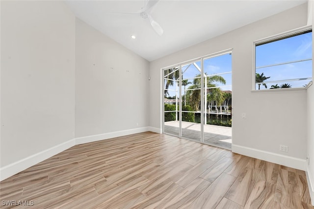 empty room featuring lofted ceiling, light hardwood / wood-style flooring, and ceiling fan