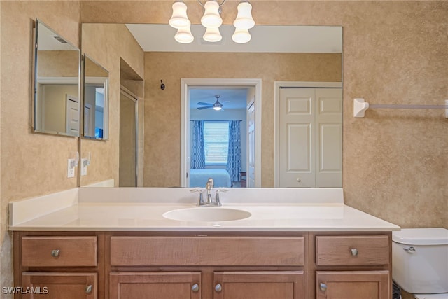 bathroom featuring vanity, an enclosed shower, and toilet