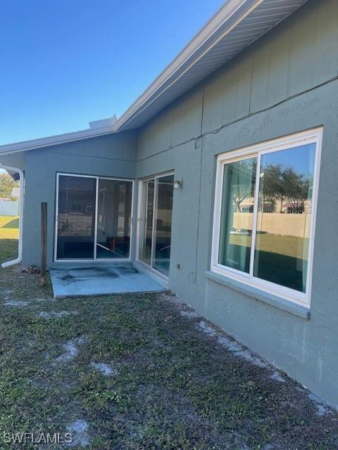 rear view of property with a lawn and a patio area