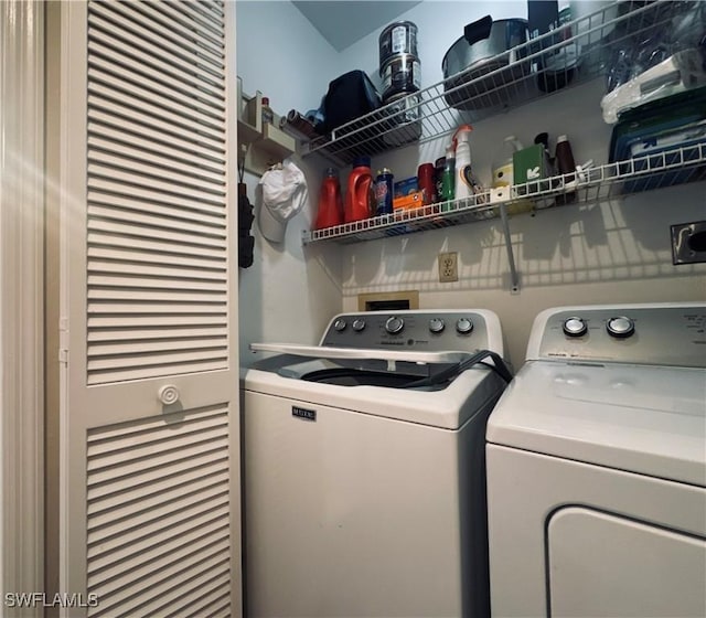 clothes washing area with washer and clothes dryer