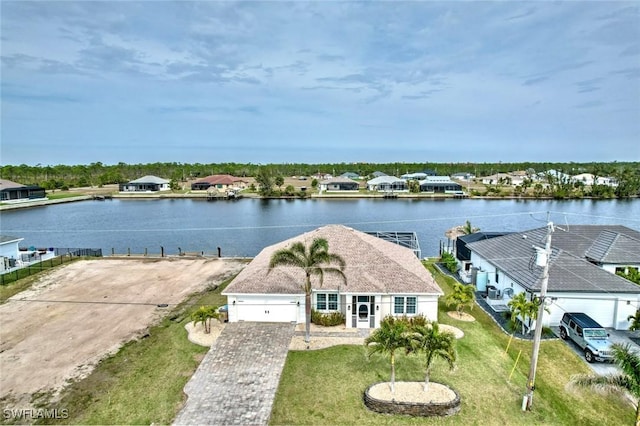 birds eye view of property with a water view