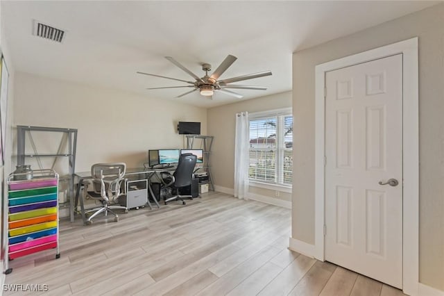 office with light hardwood / wood-style floors and ceiling fan