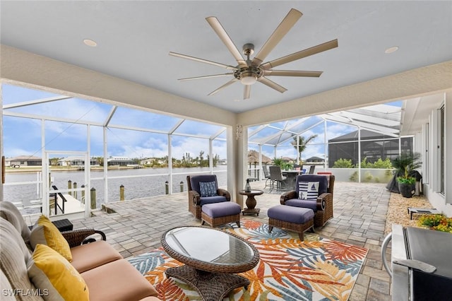 view of patio / terrace with a lanai, an outdoor hangout area, and a water view