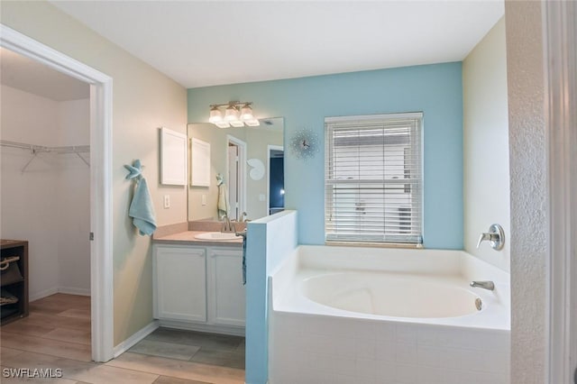 bathroom with vanity and a tub