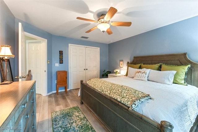 bedroom with ceiling fan, a closet, and light wood-type flooring